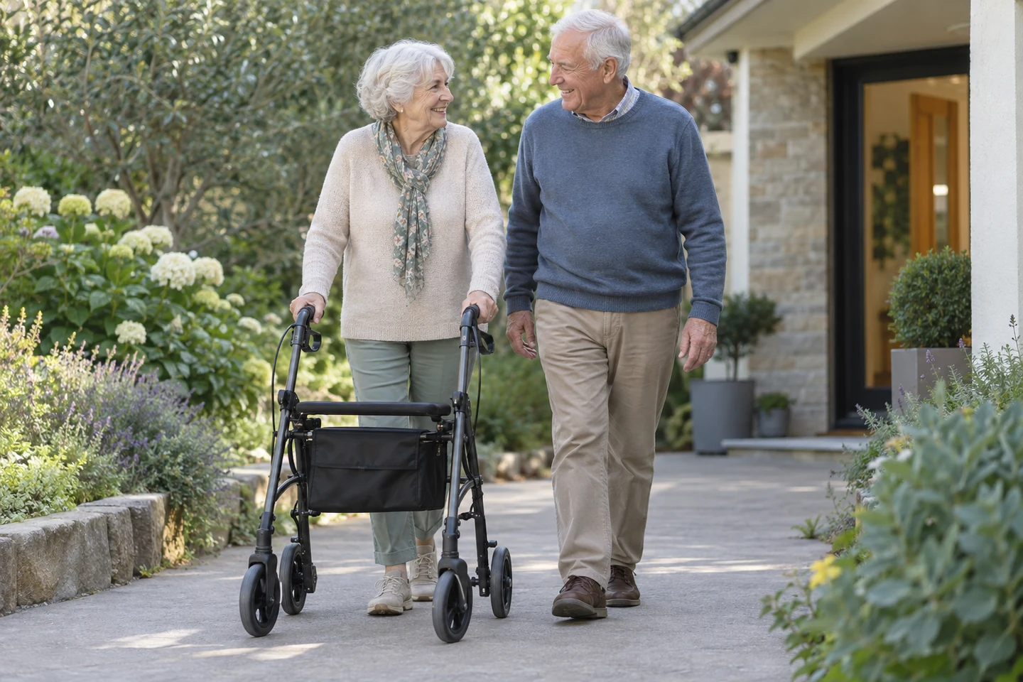 Illustrative older couple walking with a rollator in a home garden